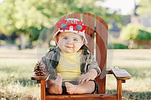 Caucasian baby boy wearing Canadian hat and funny maple leaf glasses