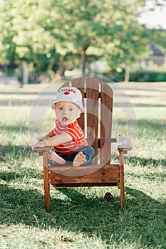 Caucasian baby boy wearing Canadian hat with maple leaf