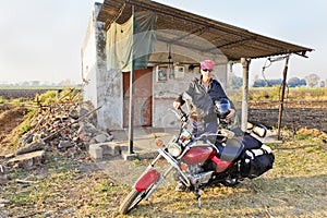 Caucasian Biker outside country shack