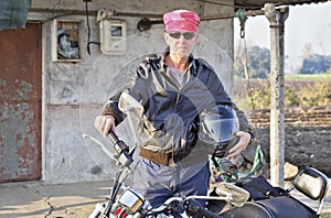 Caucasian biker outside shack hinterlands