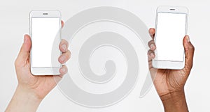 Caucasian and black hands hold cell phones. Blank screen smartphone. Copy space, mock up,blank,template. photo