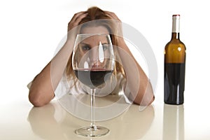 Caucasian blond wasted depressed alcoholic woman drinking red wine glass alcohol addiction