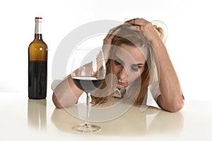 Caucasian blond wasted depressed alcoholic woman drinking red wine glass alcohol addiction