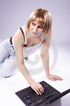 Caucasian Blond Woman Posing With Laptop Against White