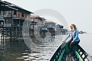 Caucasian blonde woman having a boat ride on Inle lake, Myanmar