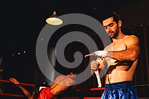 Caucasian boxer portrait wrapping his hand. Impetus