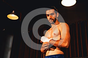 Caucasian boxer portrait wrapping his hand. Impetus