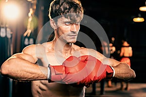 Caucasian boxer put his hand or fist wearing glove together. Impetus