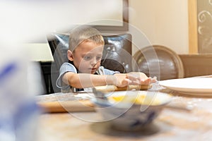 Little boy learning how to make dumplings