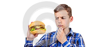 Caucasian boy eating burger and hamburger on white background,  beef