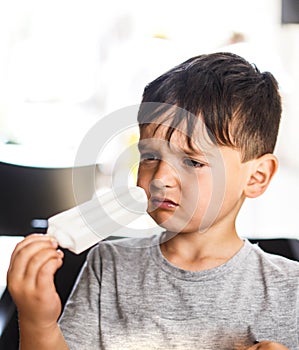 Caucasian boy enjoying a coconut lolly