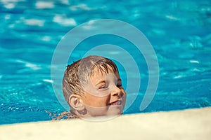 Caucasian boy swimming in the pool