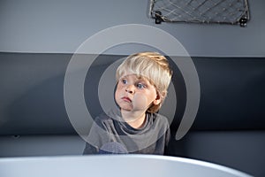 Caucasian boy in a train compartment. The passenger travels in the train cabin