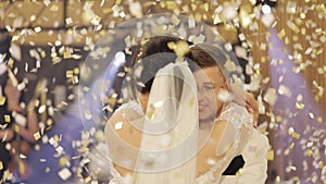 Caucasian bride, groom dancing first at the wedding party, newlyweds embracing, falling confetti