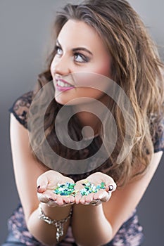 Caucasian Brunette Woman Holding New Year Confetti in Hands Prior To Blowing It Away