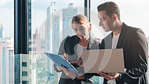 Caucasian business couple having business conversation together in office