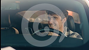 Caucasian business man auto driver smiling sit inside new automobile car city parking using smartphone looking at mobile