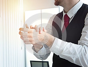 Caucasian business man in office using alcohol gel and rubbing hands back and forth to kill virus. protect from coronavirus or