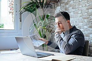 Caucasian business man trader investor analyst looking at financial stock market charts rate dynamic, trading data indexes growth