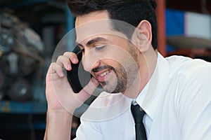 Caucasian business manager sitting, smile, calling in factory-warehouse