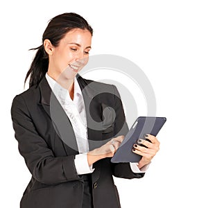 Caucasian business woman in a black suit with a smile and typing on a tablet mobile phone. Portrait on white background with