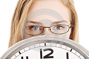 Caucasian business woman holding clock.