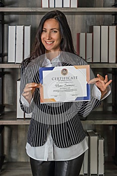 Caucasian business woman posing with certificate of appreciation recieved from business performace competition photo