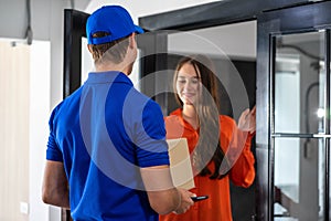 Caucasian business woman receiving package food delivery form carrier man in uniform
