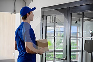 Caucasian business woman receiving package food delivery form carrier man in uniform