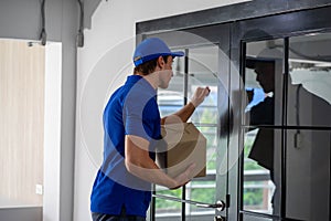 Caucasian business woman receiving package food delivery form carrier man in uniform