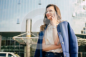 Caucasian business woman speaking by phone. Waist up portrait of a successful European business woman woman, talking on the phone