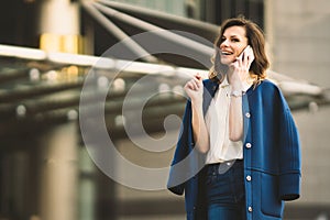 Caucasian business woman speaking by phone. Waist up portrait of a successful European business woman woman, talking on the phone