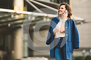 Caucasian business woman speaking by phone. Waist up portrait of a successful European business woman woman, talking on the phone