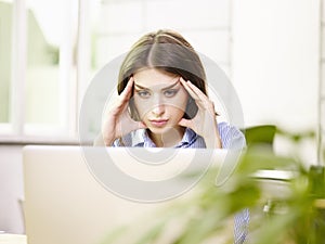 Caucasian business woman thinking in office photo