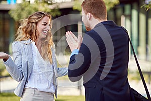 Caucasian businessman begging his female partner. fun, persuading, begging photo