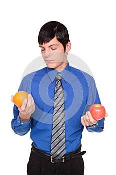 Caucasian businessman comparing apple to orange photo