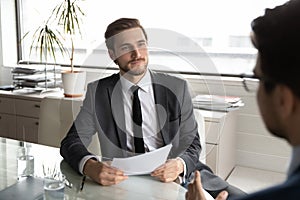 Caucasian businessman consider paperwork at meeting with business partner