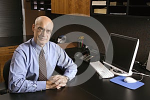 Caucasian businessman at desk.