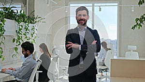 Caucasian businessman executive team leader smiling happy man looking at camera crossed arms pose in corporate office