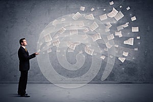 Caucasian businessman holding newspapers