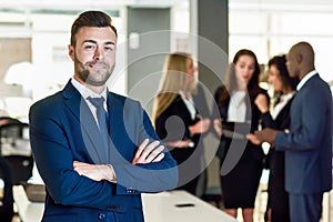 Businessman leader in modern office with businesspeople working