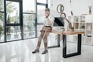 Caucasian businessman leaning on table in modern office