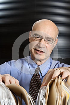 Caucasian businessman looking at files.