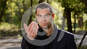 Caucasian businessman with strong serious eyesight adult confident man wear formal black suit pointing finger at camera