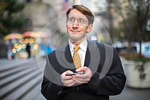 Caucasian businessman texting on cellphone