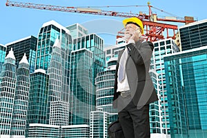 Caucasian Businessman use Digital Mobile phone at Construction S