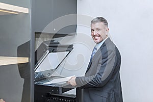 Caucasian businessman using photocopy machine