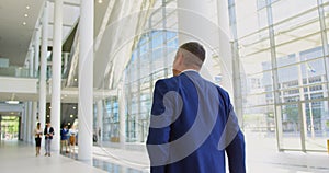 Caucasian businessman walking in the lobby at office 4k