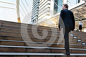 Caucasian Businessmen Walking up the stairs in the downtown