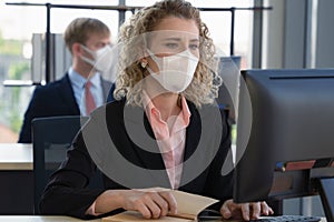 Caucasian businesspeople with medical mask for coronavirus covid-19 protection working in office